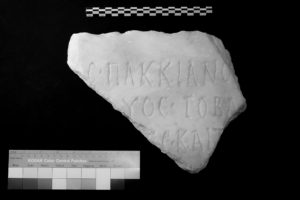 The first set of images in the fragmentary inspection, with a poorly lighted view of the text engraved on the front of a stone. The image is in black and white.