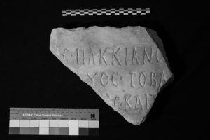 The first set of images in the fragmentary inspection, with a detailed view of the text engraved on the front of a stone as a result of changed lighting. The image is in black and white.