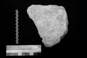 The second set of images in the fragmentary inspection, with a poorly lit view of the text engraved on the front of a stone. The image is in black and white.