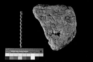 The second set of images in the fragmentary inspection, with a detailed view of the text engraved on the front of a stone as a result of changed lighting. The image is in black and white.